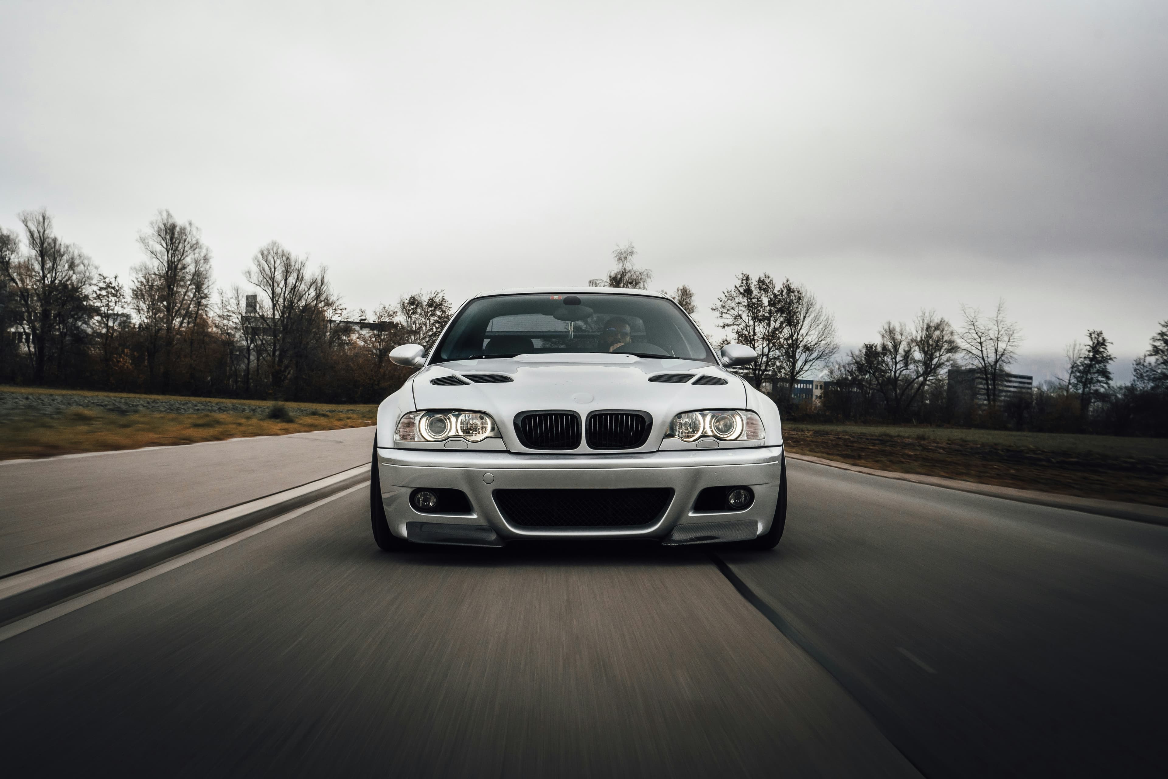 Silver BMW M3 E46 photographed head-on while driving