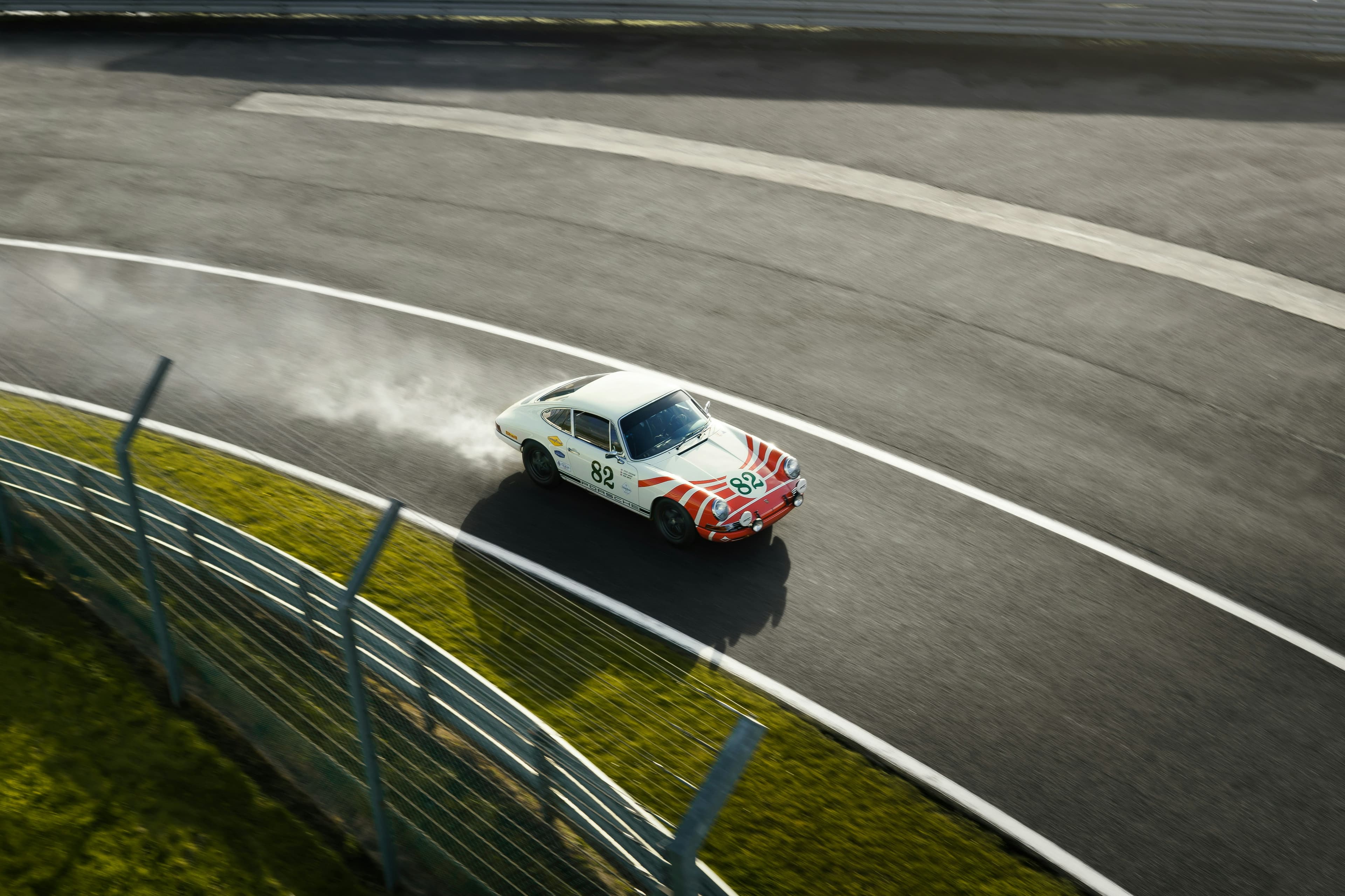 Vintage race car driving through a circuit corner
